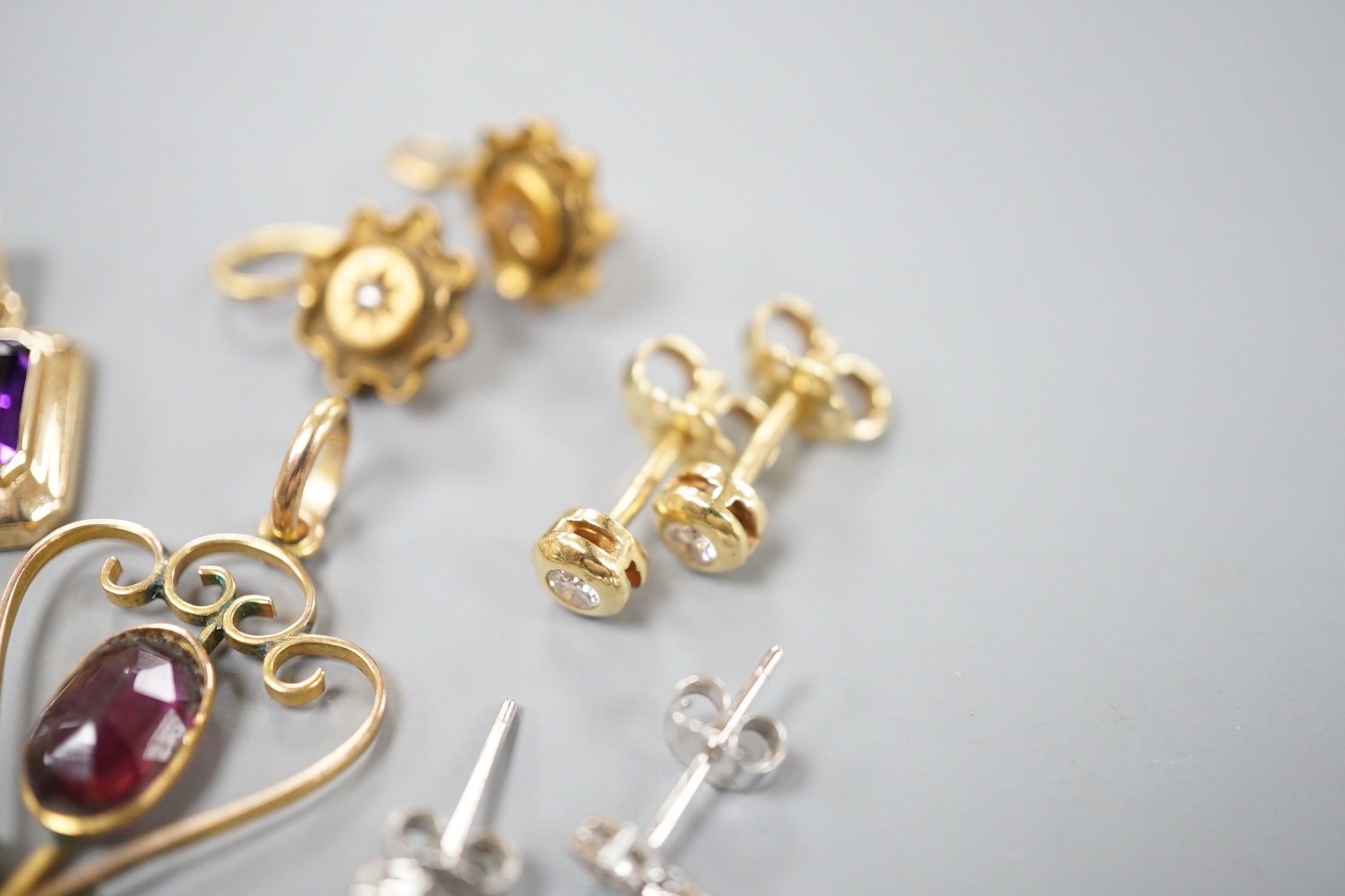 Mixed jewellery including a pair of Victorian 15ct and diamond chip earrings, a modern amethyst pendant, a garnet set yellow metal pendant, two pairs of 750 and diamond set ear studs, a pair of 750 white metal, tanzanite